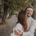 a man holding a woman in his arms in a park
