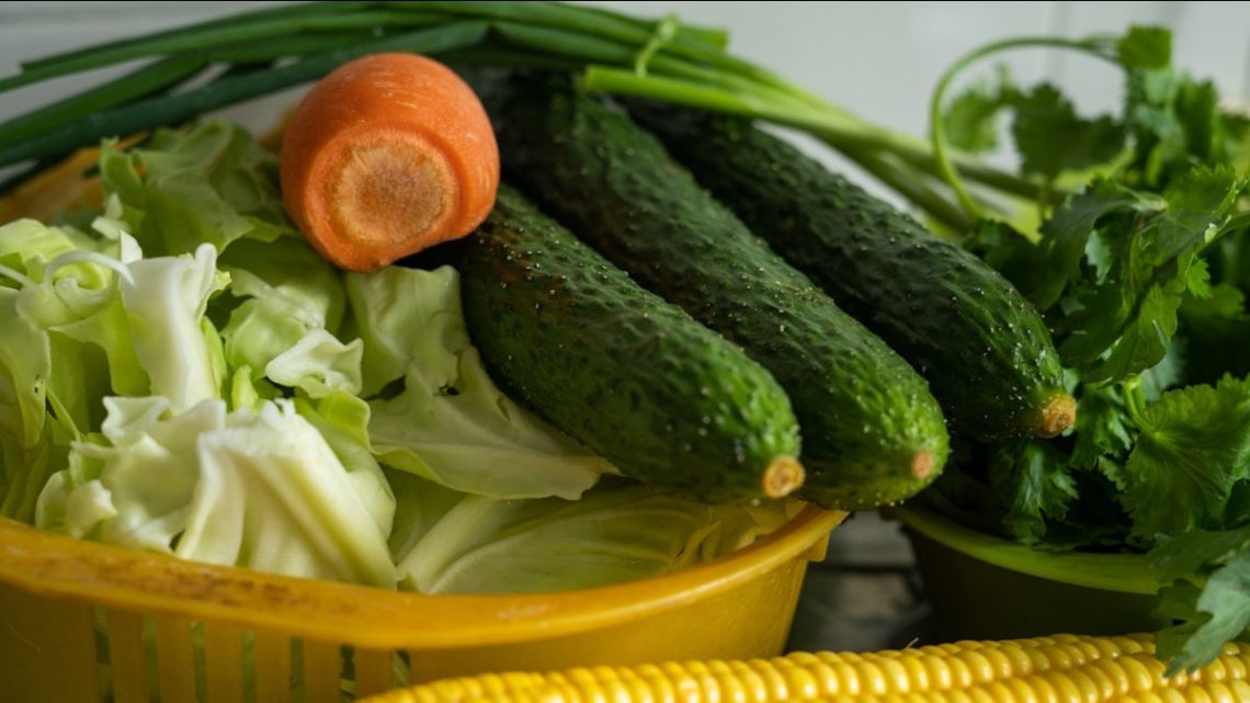 corn and green vegetable on yellow plastic container