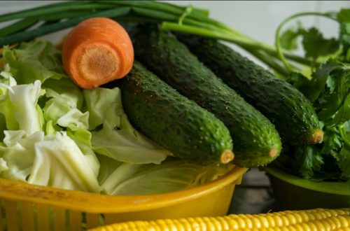 corn and green vegetable on yellow plastic container